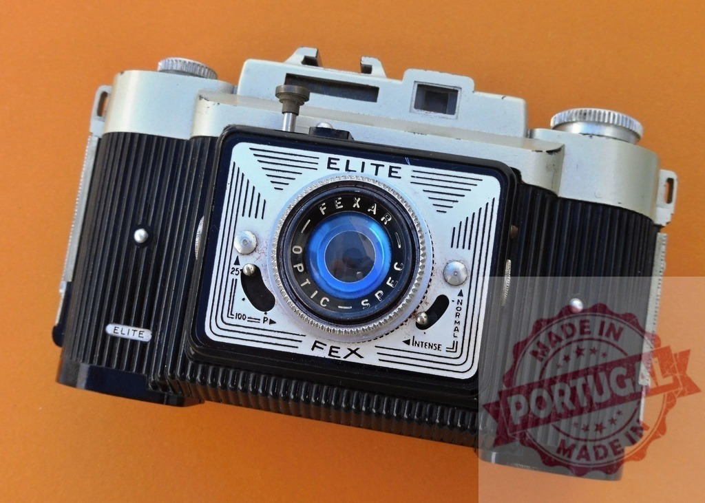 FEX Elite vintage camera representing retro photography and nostalgia | FEX Elite vintage film camera with Fexar Optic lens on an orange background - Realized with Pictrs.com