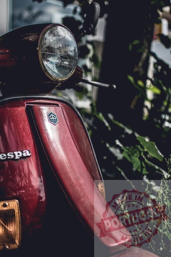 Red Vespa Scooter Parked Near Green Plants | Close-up of a classic red Vespa scooter parked outdoors, with green foliage in the background - Realisiert mit Pictrs.com