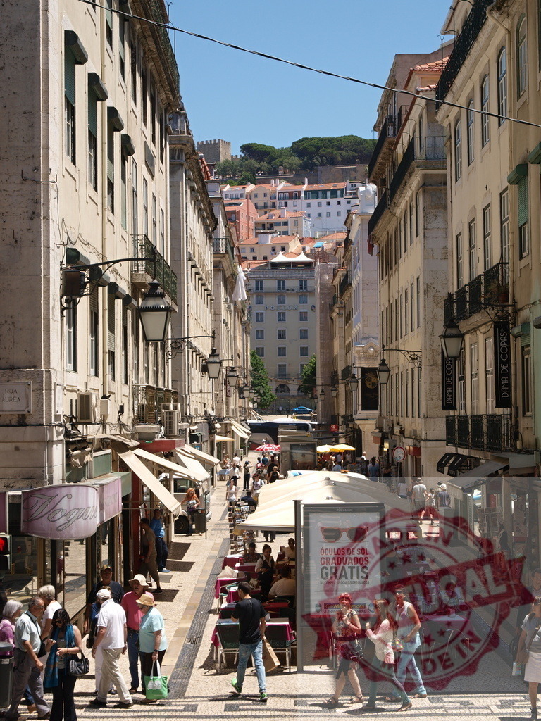 Lisbon Baixa street with people walking and shopping. Lisbon - Portugal | People walking along a busy street in Lisbon's Baixa district creating a vibrant city scene - Realisiert mit Pictrs.com