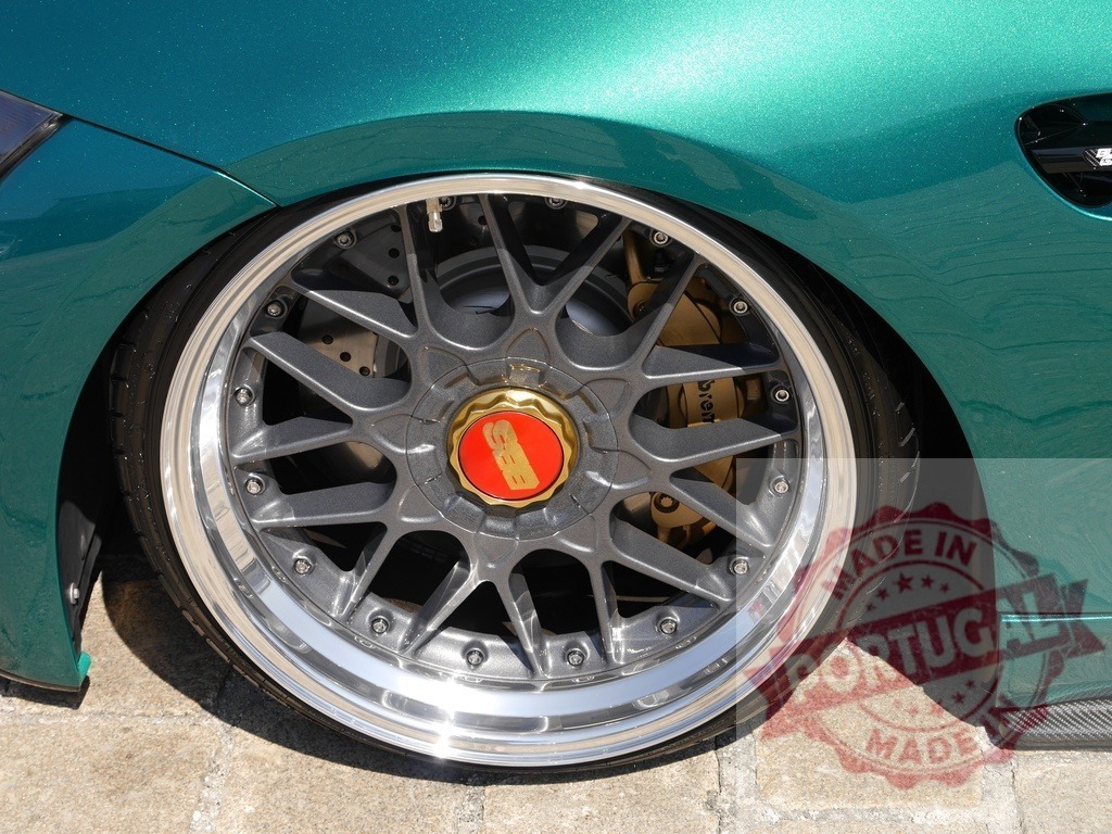Lowered green car with custom BBS wheels | Custom low rider green car showing aftermarket BBS wheel and Brembo brake - Realized with Pictrs.com