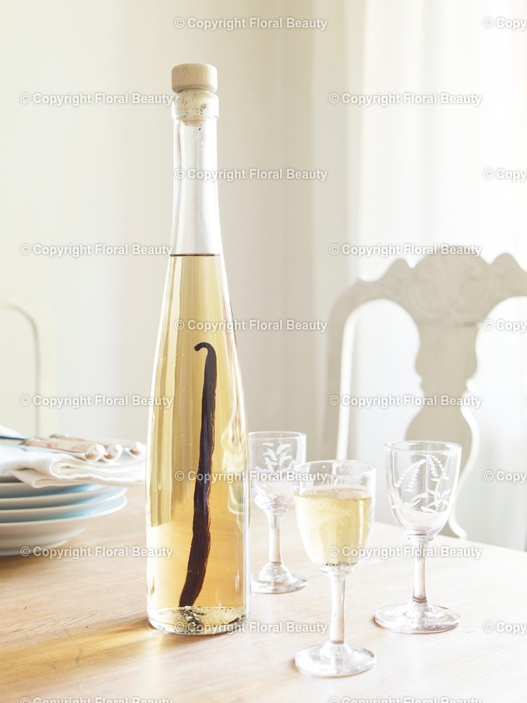 Vanillelikör | Vanillelikör mit Vanilleschote steht auf dem Tisch mit drei Gläsern. - Realisiert mit Pictrs.com