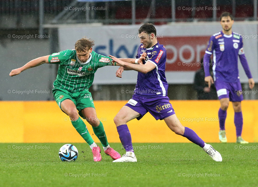 A_LUI_10032024_16 | SPORT,FUSSBALL, ADMIRAL BUNDESLIGA AUSTRIA KLAGENFURT-SK RAPID WIEN 10.03.2024 IM BILD: ANDREW IRVING (KLAGENFURT) UND LEOPOLD QUERFELD (RAPID WIEN) FOTO:FOTOLUI/MW