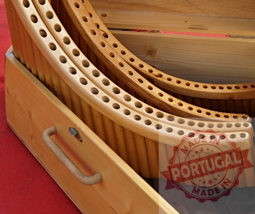 Wooden panpipes resting in their case emitting warm tones | Panpipes stored in a wooden case, ready to create enchanting melodies - Realized with Pictrs.com