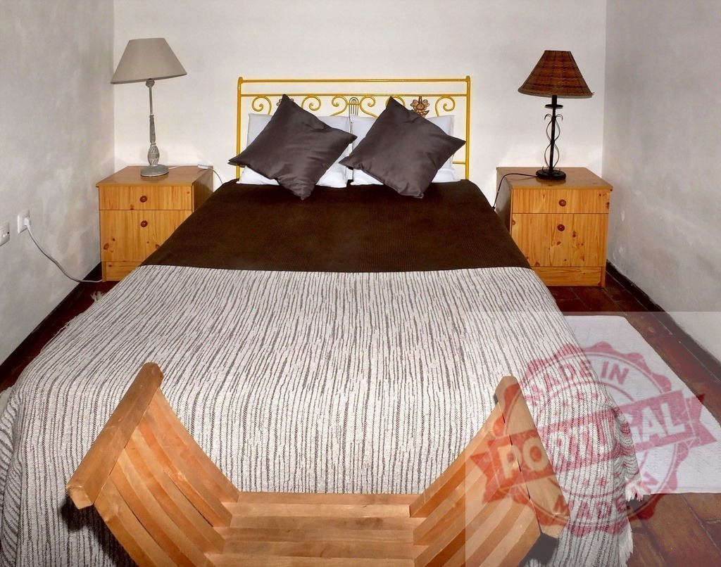 Cozy bedroom interior with bed and nightstands | Bedroom interior featuring a bed, two nightstands, and decorative lamps, providing a comfortable lodging space - Realized with Pictrs.com