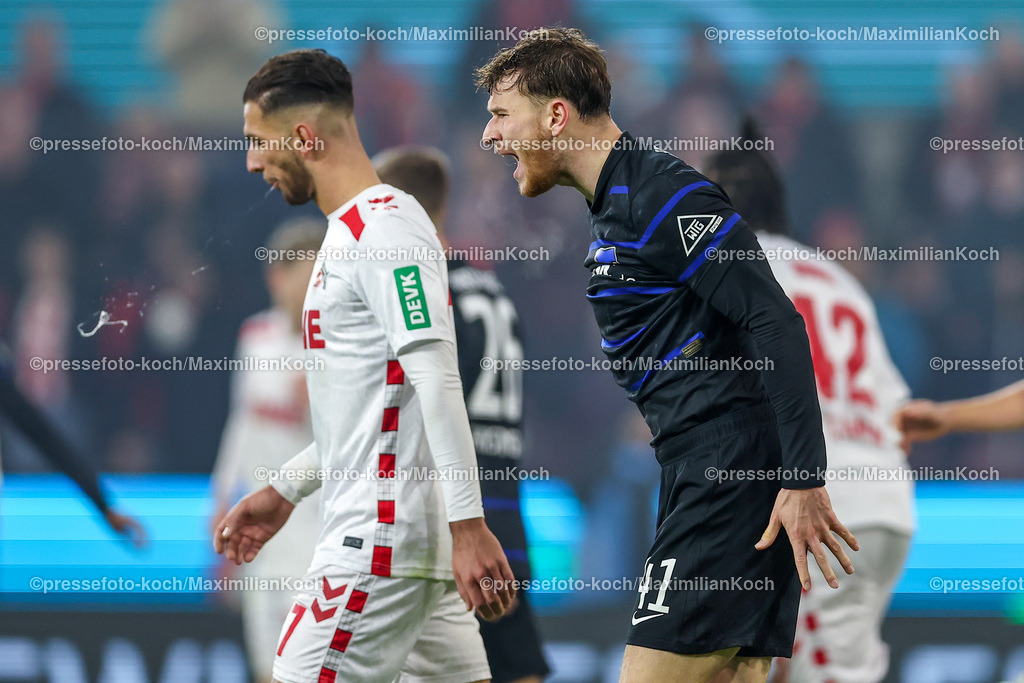 1FC04122401097 | 04.12.2024, Fußball, 1. FC Köln - Hertha BSC, Achtelfinale DFB-Pokal, RheinEnergieSTADION, Saison 2024 2025: Enttäuschung nach dem Ausscheiden von Hertha - Pascal Klemens (Hertha #41) steht enttäuscht auf dem SpielfeldDFB regulations prohibit any use of photographs as image sequences and or quasi-video.