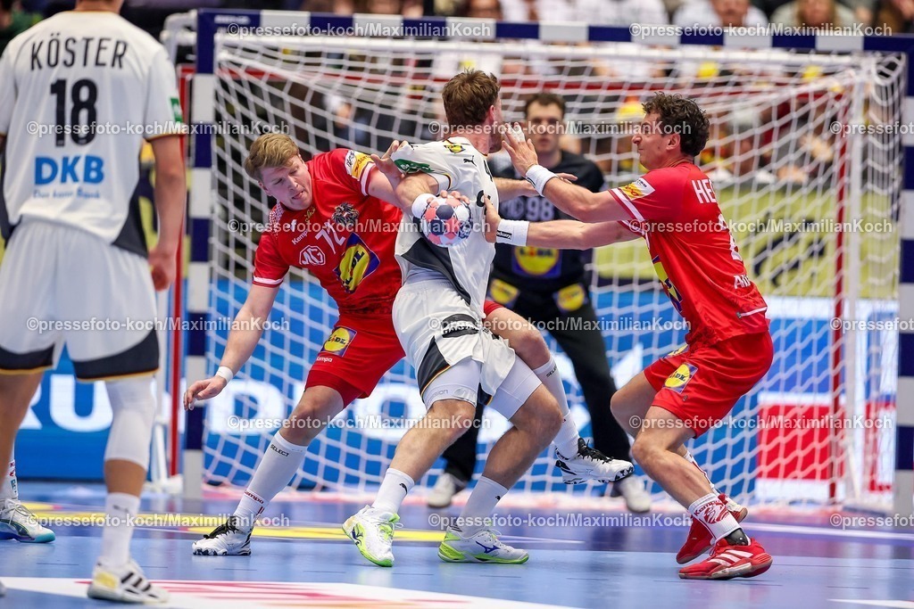 EHF15012602042 | 15.01.2026, Handball, Men's EHF EURO 2026, Deutschland - Östereich, Jyske Bank Boxen in Herning, Dänemark, Preliminary Round:  Johannes Golla (Germany #04) im Zweikampf gegen   Lukas Hutecek (Austria #72)  Nemanja Belos (Austria #23) 