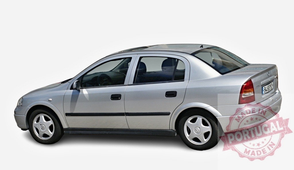 Silver Opel Astra sedan parking on white background | Classic silver Opel Astra sedan car parking on white background, showcasing its sleek design and timeless appeal - Realisiert mit Pictrs.com