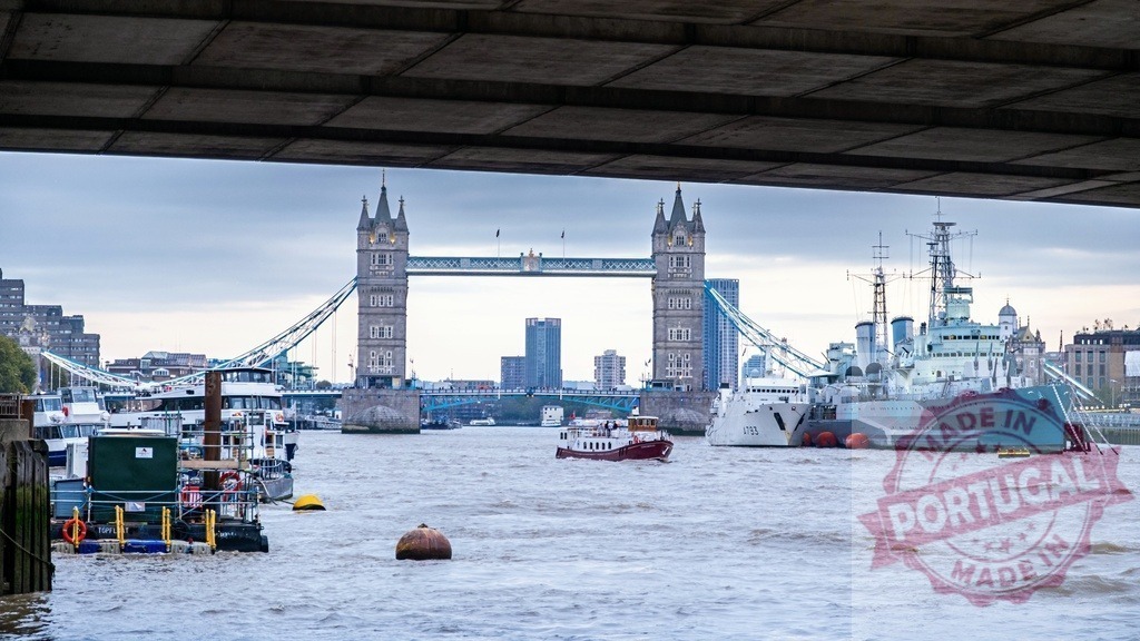 London Tower Bridge over River Thames with HMS Belfast | Tower Bridge and HMS Belfast standing on the River Thames with boats passing by - Realized with Pictrs.com