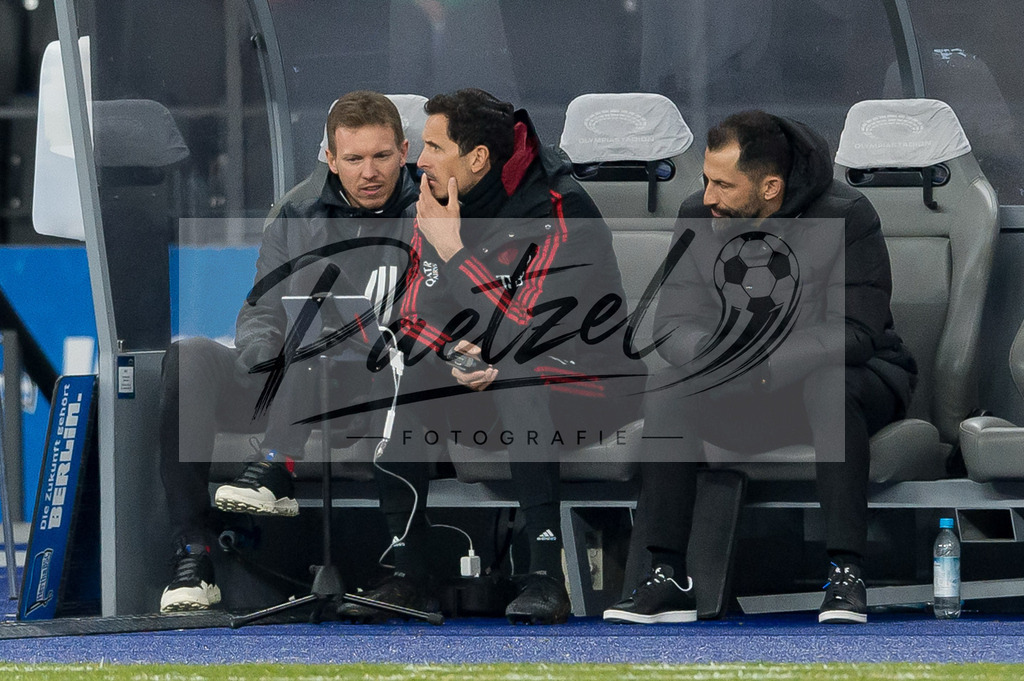 BSCFCB20220123_104 | Fussball, Herren: Trainer Julian Nagelsmann (FC Bayern Muenchen), Co-Trainer Dino Toppmoeller (FC Bayern Muenchen) und Sport-Vorstand Hasan Salihamidzic (FC Bayern Muenchen) schauen bei dem Spiel der 1. Bundesliga zwischen Hertha BSC und FC Bayern Muenchen im Olypiastadion am 23.01.2022 in Berlin, Deutschland.DFB / DFL REGULATIONS PROHIBIT ANY USE OF PHOTOGRAPHS AS IMAGE SEQUENCES AND/OR QUASI-VIDEO. - Realisiert mit Pictrs.com
