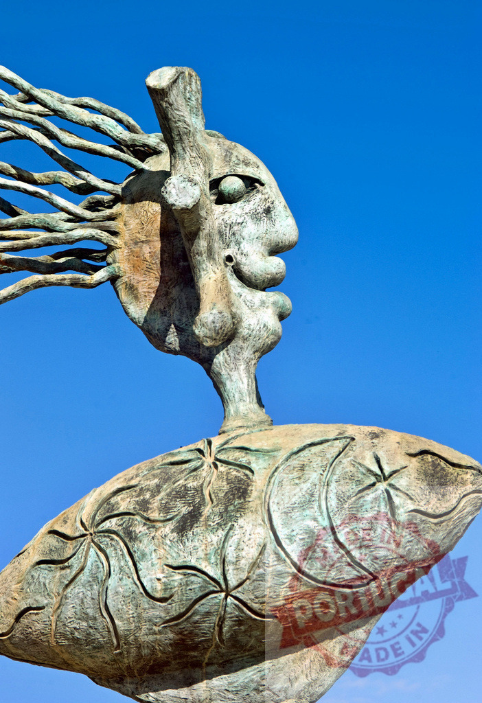 Joan Miró bronze sculpture fish face and stars in Palma de Mallorca | Modern abstract bronze sculpture showing a face with flowing hair on a fish body against a blue sky - Realized with Pictrs.com