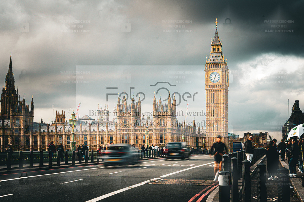 Westminster Views – Big Ben & Parliament | Ein klassischer Blick über die Westminster Bridge auf das imposante Parlamentsgebäude mit dem ikonischen Big Ben.Das wechselhafte Londoner Licht und die Bewegung der vorbeiziehenden Menschen und Fahrzeuge verleihen der Szene eine lebendige Dynamik – ein Moment zwischen Tradition, Alltag und Großstadtenergie. - Realisiert mit Pictrs.com