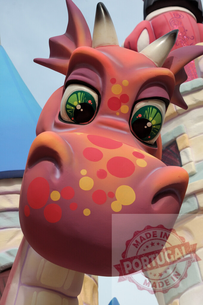 Figment character welcoming guests at Epcot Imagination pavilion | Figment character sculpture smiling, representing imagination and creativity at a theme park - Realized with Pictrs.com