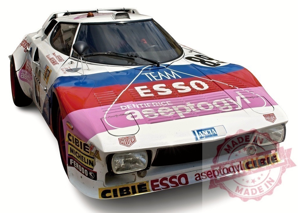 Lancia Stratos Gr.4 showcasing Esso and Aseptogyl sponsorship at race | Vintage Lancia Stratos Gr.4 rally car displaying prominent Esso and Aseptogyl sponsorship, parked before a race - Realisiert mit Pictrs.com