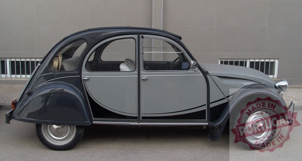 Classic Citroën 2CV parked near a modern building with open doors | Grey and black vintage Citroën 2CV parked on the street with open doors, showcasing its timeless design - Realized with Pictrs.com
