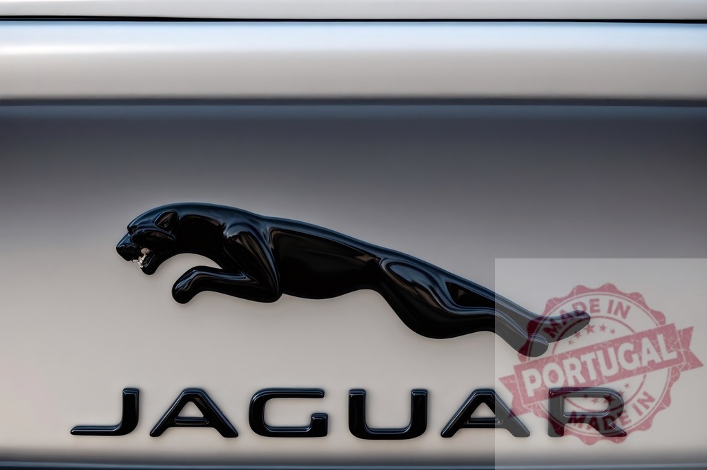 Jaguar car logo showing black leaping feline symbol | Jaguar car brand emblem on a metallic surface, illustrating luxury and power - Realized with Pictrs.com