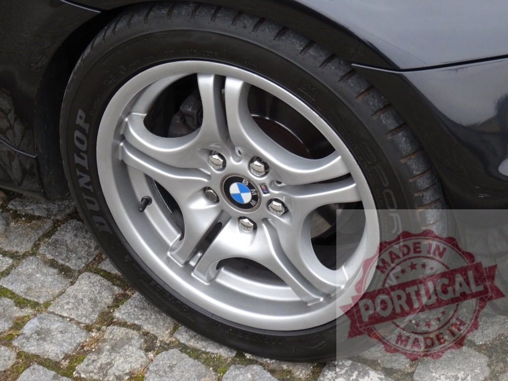 BMW car wheel with Dunlop Sport Maxx tire | BMW car's alloy wheel with a high-performance tire on a cobblestone surface - Realized with Pictrs.com