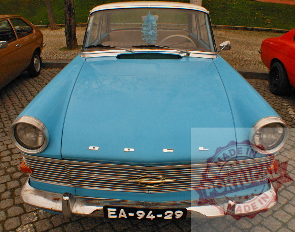 Light blue Opel Rekord P1 parked in cobblestone square | Classic light blue Opel Rekord P1 parked in cobblestone square, showing front view - Realized with Pictrs.com