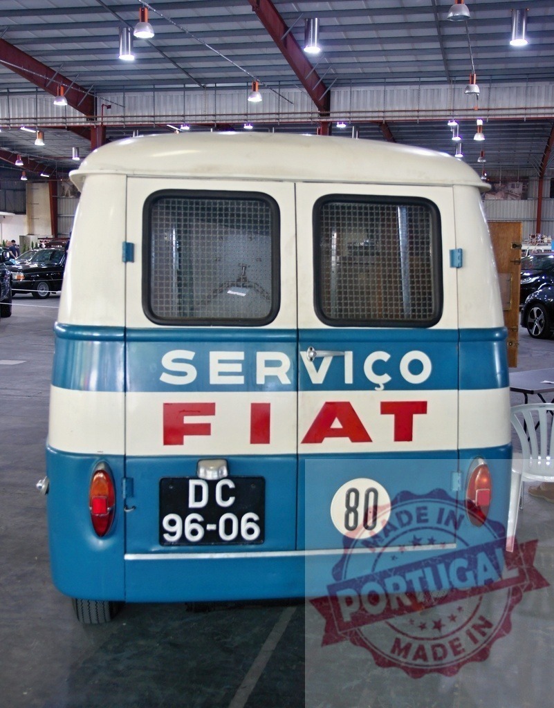 Rear view of vintage FIAT service van parked indoors | Back view of a classic FIAT 80 service van parked inside a garage, showing its blue and white paint, rear windows, and license plate - Realized with Pictrs.com