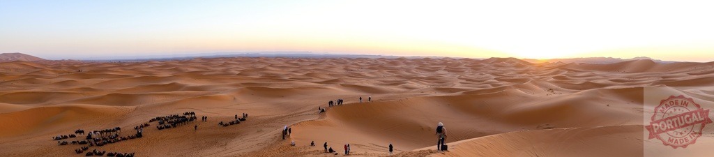 Tourists watching sunrise over Sahara Desert dunes in Morocco | Tourists watching the sunrise over the sand dunes of Erg Chebbi in the Sahara Desert in Morocco - Realized with Pictrs.com