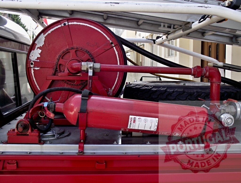 Fire truck equipment with hose reel and extinguisher | Firefighting equipment including a red hose reel and powder fire extinguisher on a truck - Realized with Pictrs.com