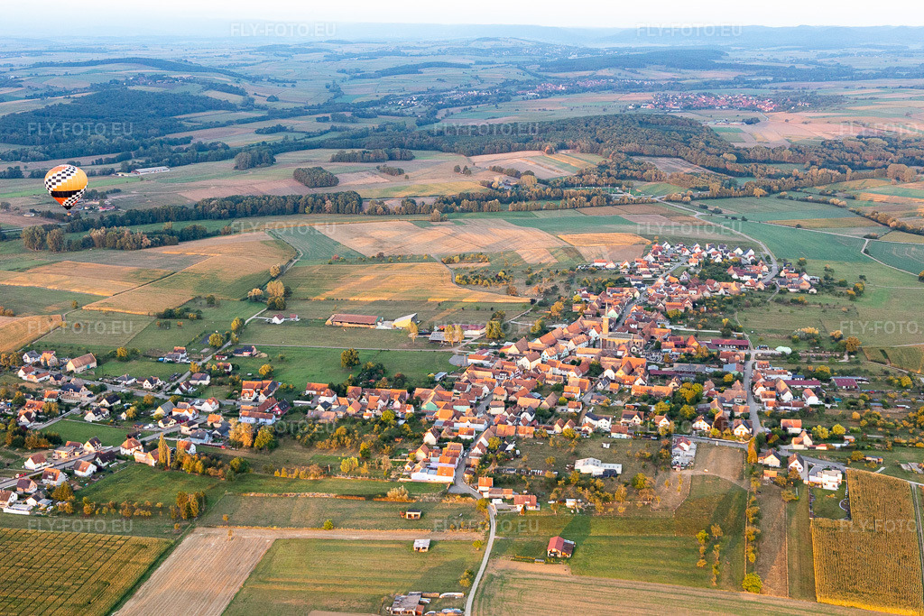 Vue aérienne: Des terres agricoles et des champs entourent la zone d'habitation du village où l'on aperçoit des montgolfières. à Kindwiller dans le département Bas Rhin, France.Photo: IMG_117781.jpg prise le 14/09/2019 par Werner Riehm/FLY-FOTO.euRésolution de l'original: 5472 x 3648 px