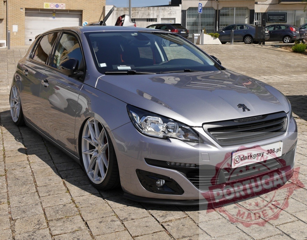 Peugeot 308 lowered custom car parked | Grey Peugeot 308 hatchback showcasing custom wheels and lowered suspension, parked on paving stones - Realized with Pictrs.com