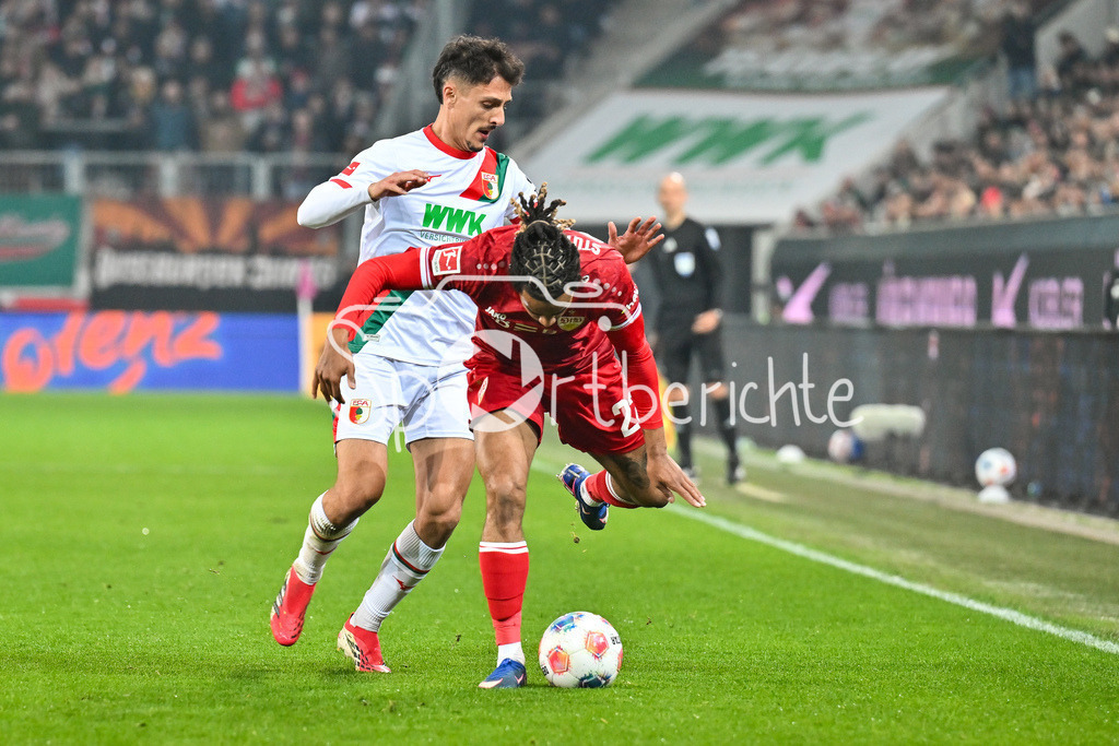 FC Augsburg - VfB Stuttgart | AUGSBURG, GERMANY - 22. MAERZ: im Duell Dimitrios GIANNOULIS (FC Augsburg 13) und Lorenz ASSIGNON (VfB Stuttgart 22) während dem Bundesligamatch zwischen dem FC Augsburg und dem VfB Stuttgart am 27. Spieltag in der WWK Arena / DFL REGULATIONS PROHIBIT ANY USE OF PHOTOGRAPHS AS IMAGE SEQUENCES AND/OR QUASI-VIDEO