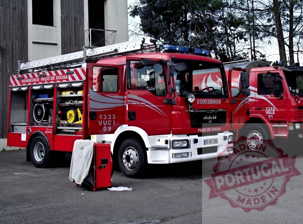 Red MAN fire truck standing at Bombeiros Paço de Sousa station | Red fire trucks from Bombeiros Paço de Sousa ready for emergency rescue operations - Realized with Pictrs.com