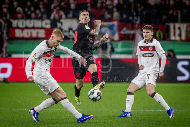 Bayer 04 Leverkusen vs. FC St. Pauli, 03.02.2026 | LEVERKUSEN, GERMANY - FEBRUARY 3:  Louis Oppie (FC St. Pauli, 23), Alejandro Grimaldo (Bayer 04 Leverkusen, 20), Arkadiusz Pyrka (FC St. Pauli, 11)during the DFB Cup quarter-final match Bayer 04 Leverkusen vs. FC St. Pauli at BayArena on February 3, 2026 in Leverkusen, Germany. (Photo by Axel Kohring/Beautiful Sports Int.)DFL REGULATIONS PROHIBIT ANY USE OF PHOTOGRAPHS AS IMAGE SEQUENCES AND/OR QUASI-VIDEO.