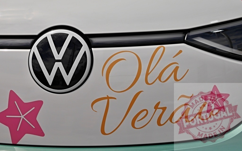 Volkswagen logo with Olá Verão text on car | Volkswagen car displaying Olá Verão message and starfish shapes, symbolizing summer travel - Realisiert mit Pictrs.com