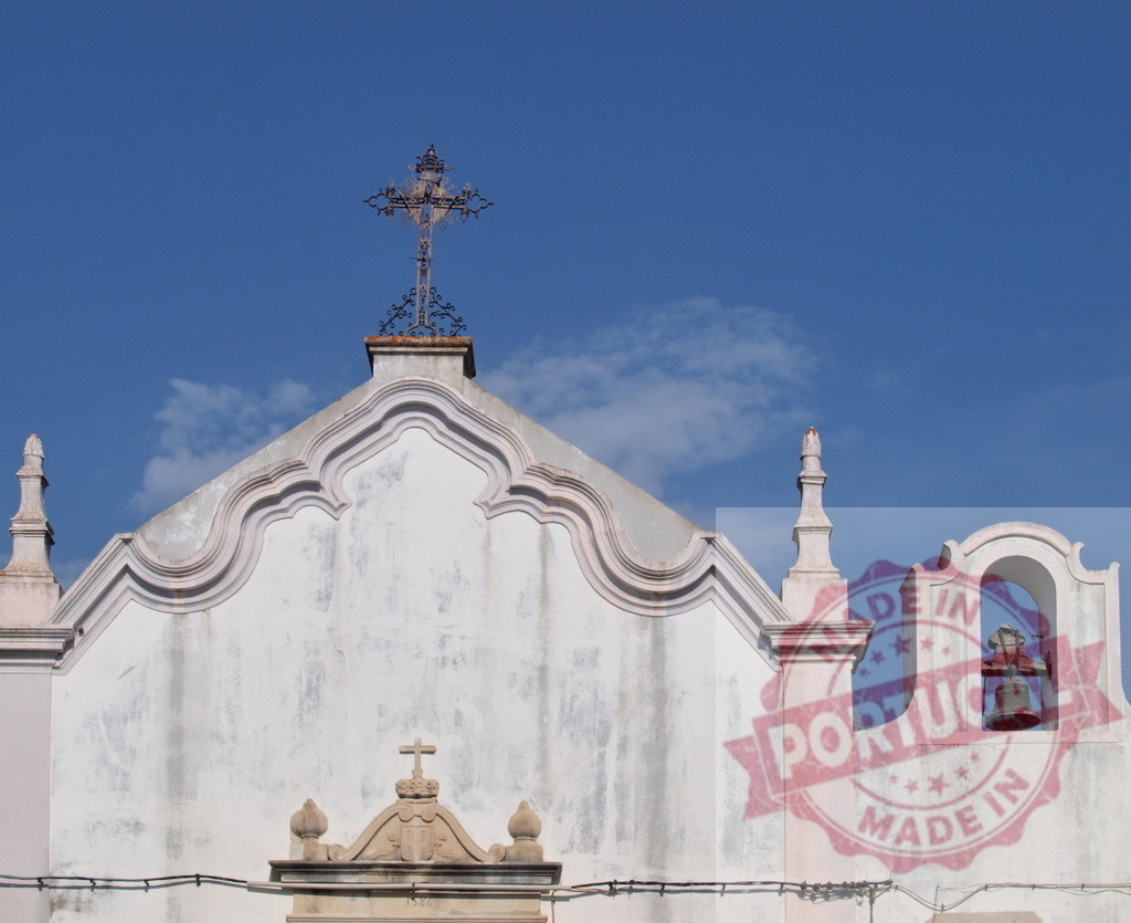 Old church facade with cross and bell against blue sky | Old building facade of a christian church with bell and cross against clear blue sky - Realized with Pictrs.com