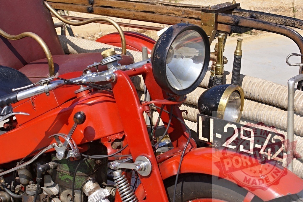 Vintage red firefighter motorcycle engine detail | Close up view of an old red motorcycle used by firefighters, showing its vintage equipment - Realized with Pictrs.com