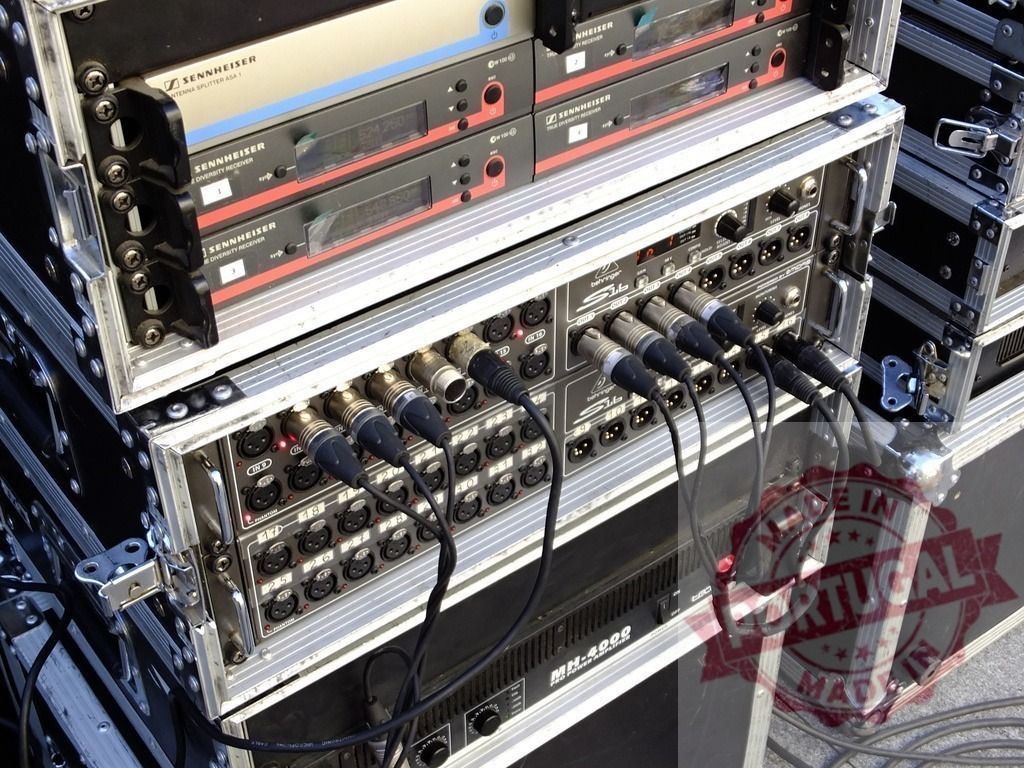 Professional audio equipment setup featuring Sennheiser and other brands, ready for a live event | Flight cases containing mixing consoles, microphones, wireless receivers, amplifiers and other audio equipment, prepared for a concert or other live event - Realisiert mit Pictrs.com