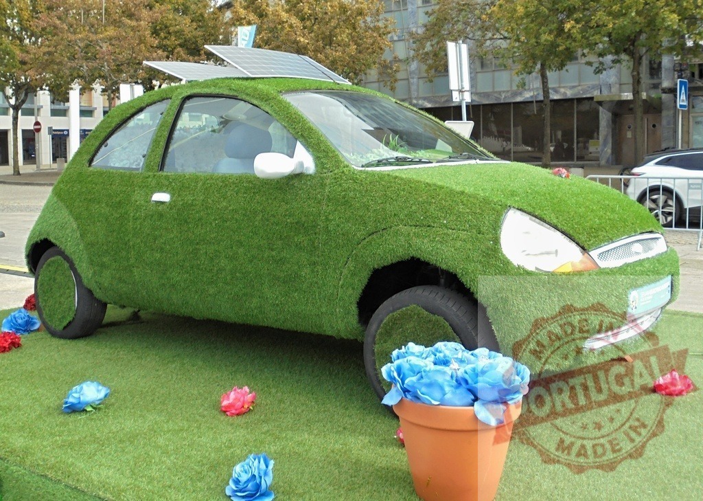 Green car wrapped in artificial grass with solar panels | Car covered in artificial grass and solar panels representing eco-friendly transportation concept - Realized with Pictrs.com