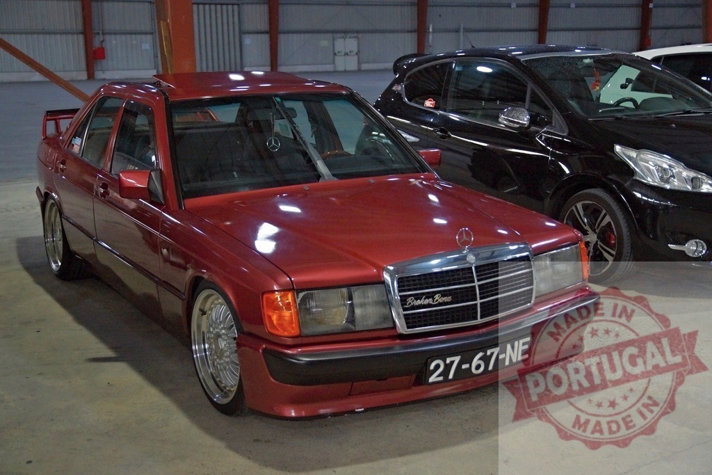 Red Mercedes-Benz 190 W201 sedan tuning show | Custom red Mercedes-Benz 190 W201 classic car showcasing modified wheels and low suspension - Realisiert mit Pictrs.com