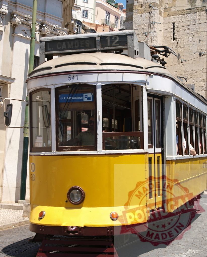 Yellow Lisbon Tram Passing Through City Street in Portugal | Yellow vintage tram number 541 driving through Lisbon's streets in Portugal - Realized with Pictrs.com