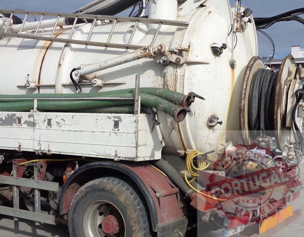 Septic vacuum truck with industrial hoses | Septic vacuum truck carrying hoses and equipment for waste removal services - Realized with Pictrs.com
