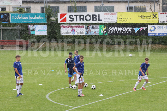 Friendly Match: SC Weiz vs TSV Hartberg in Weiz | Weiz, AUSTRIA, 01.JUL.26 - SOCCER - ADMIRAL Bundesliga, SC Weiz vs TSV Hartberg, test match. The image shows heavy rain during warm up from TSV Hartberg.
