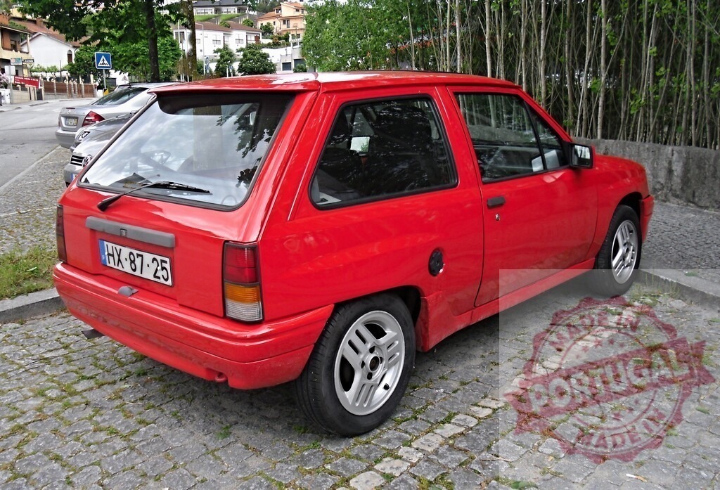 Red Opel Corsa parked on cobblestone street | Red Opel Corsa hatchback parked on a historic cobblestone street, showcasing vintage compact car design - Realisiert mit Pictrs.com