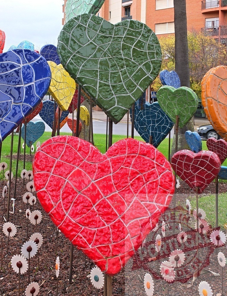 Colorful mosaic hearts forming an art installation | Mosaic hearts standing in a garden, creating a vibrant public art display - Realized with Pictrs.com