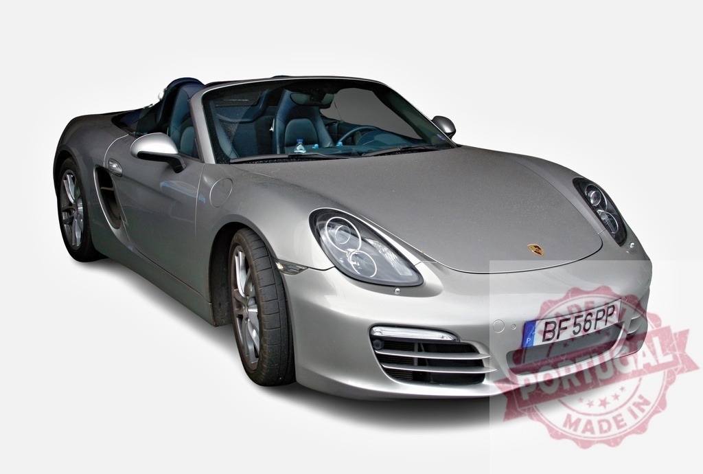 Silver Porsche Boxster sports car parked with open roof | Stylish silver Porsche Boxster roadster parked with its roof down, showcasing luxury and performance - Realized with Pictrs.com