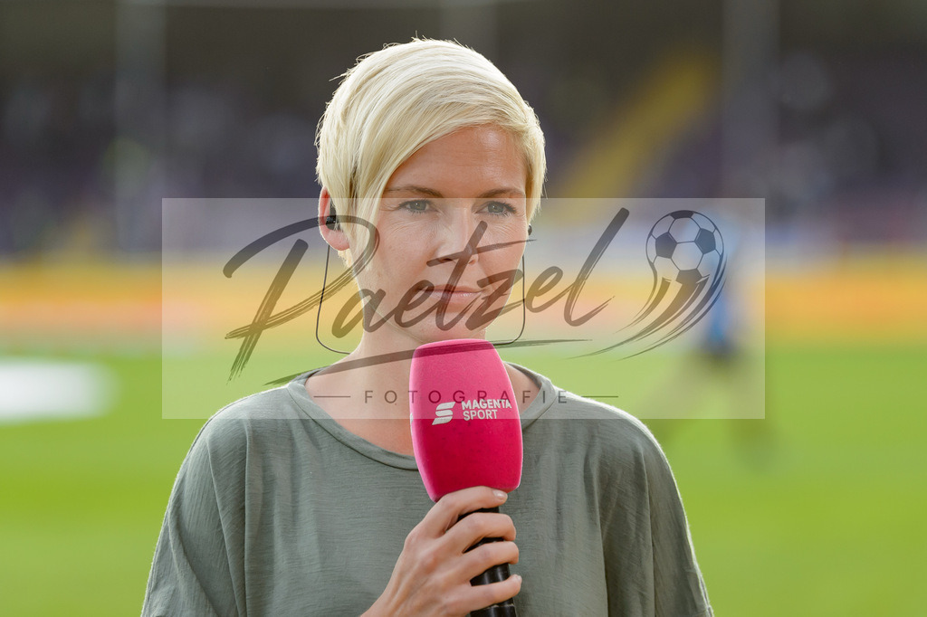 OSNVKO2021090620210906_253 | Fussball, Herren: MagetaSport-Moderatorin Anett Sattler schaut beim Spiel der 3. Liga zwischen VfL Osnabrueck und FC Viktoria Koeln im Stadion an der Bremer Bruecke am 06.09.2021 in Osnabrueck, Deutschland.DFB / DFL REGULATIONS PROHIBIT ANY USE OF PHOTOGRAPHS AS IMAGE SEQUENCES AND/OR QUASI-VIDEO. - Realisiert mit Pictrs.com