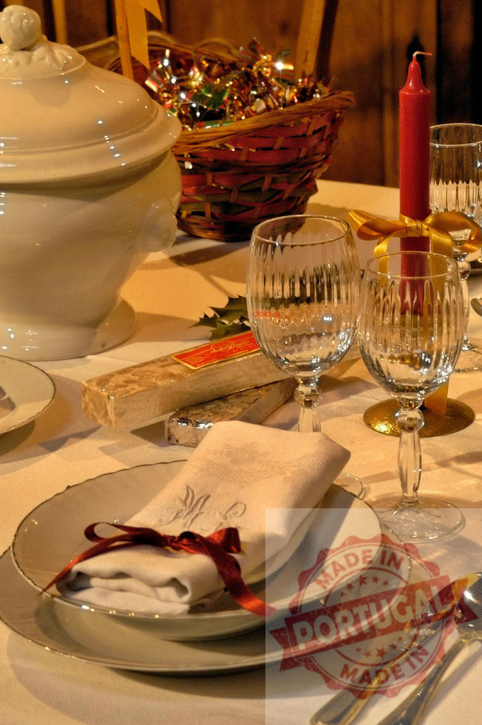 Christmas table setting with nougat, candle and candies | Elegant Christmas table setting with traditional nougat, red candle and candies, ready for Christmas Eve dinner - Realized with Pictrs.com