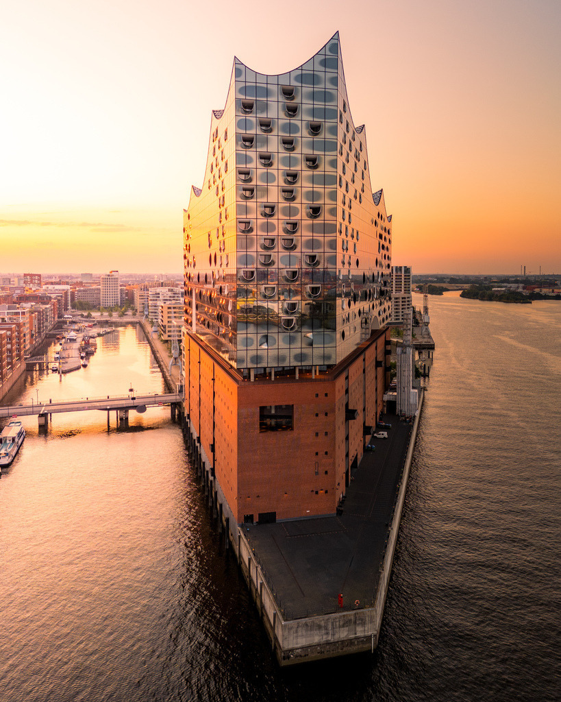 Elbphilharmonie aus der Vogelperspektive im Abendlicht | Außergewöhnlicher Drohnenblick auf die Elbphilharmonie zwischen HafenCity und Elbe im warmen Licht des Sonnenaufgangs. - Realisiert mit Pictrs.com
