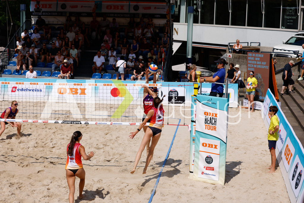 Obi BeachTour 2026 - Basel | BASEL, SWITZERLAND - JULY 17: NADINE DEMIERRE (SUI) attack / spike against ANJA GÄHWILER (SUI) block during the Obi BeachTour 2026 match between FLÜCKIGER / DEMIERRE (SUI) and EUGSTER / GÄHWILER (SUI) at Barfüsserplatz on July 17, 2026 in Basel, Switzerland. - Realisiert mit Pictrs.com