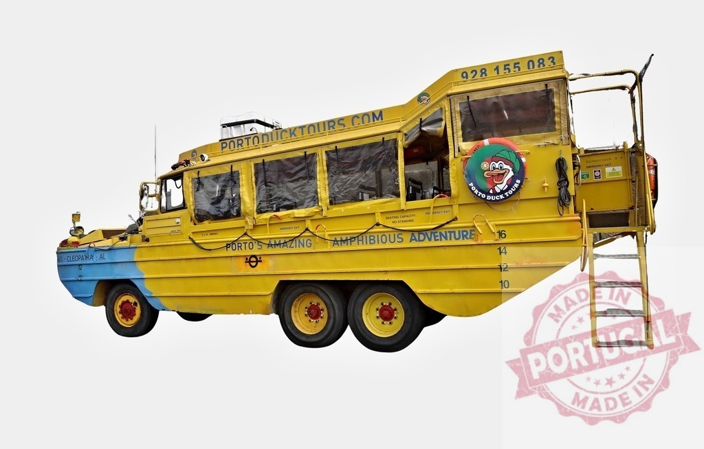 Yellow and blue amphibious tour bus parked on land, ready to explore Porto by land and water | Yellow and blue amphibious vehicle parked on land, offering Porto's amazing amphibious adventure - Realized with Pictrs.com