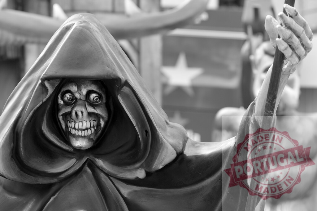 Grim Reaper figure with terrifying skull face and cloak | Grim Reaper figure with a skull face and hooded cloak holding a staff - Realized with Pictrs.com