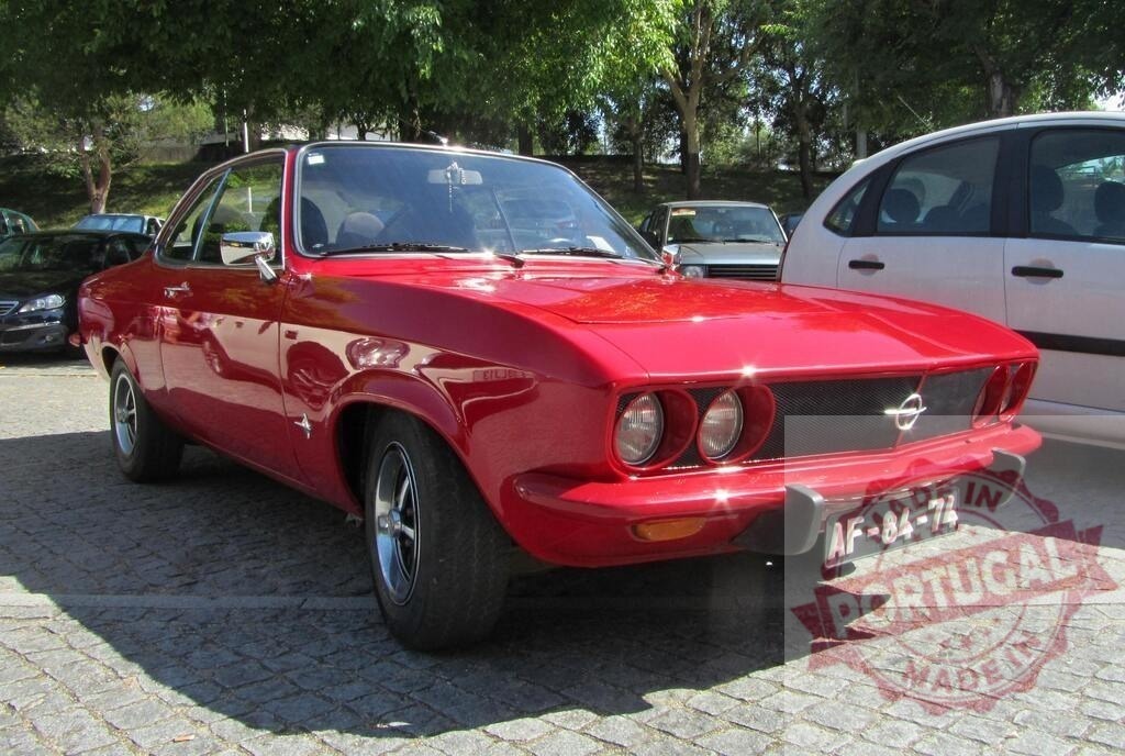 Shiny red Opel Manta A parked in a parking lot | Classic Opel Manta A glistening under the sun in a parking lot - Realisiert mit Pictrs.com