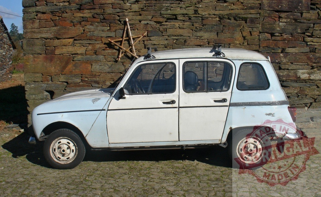 Old Renault 4 car parking near stone wall | Vintage Renault 4 hatchback parking on paving next to a rustic stone wall - Realized with Pictrs.com