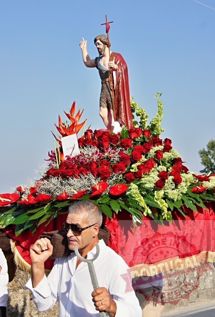 Men carrying statue of Saint John the Baptist during a religious procession | Procession 15.08.2025 - Assumption Day - Paco de Sousa, Portugal Devotee carrying a statue of Saint John the Baptist during a traditional religious procession - Realized with Pictrs.com